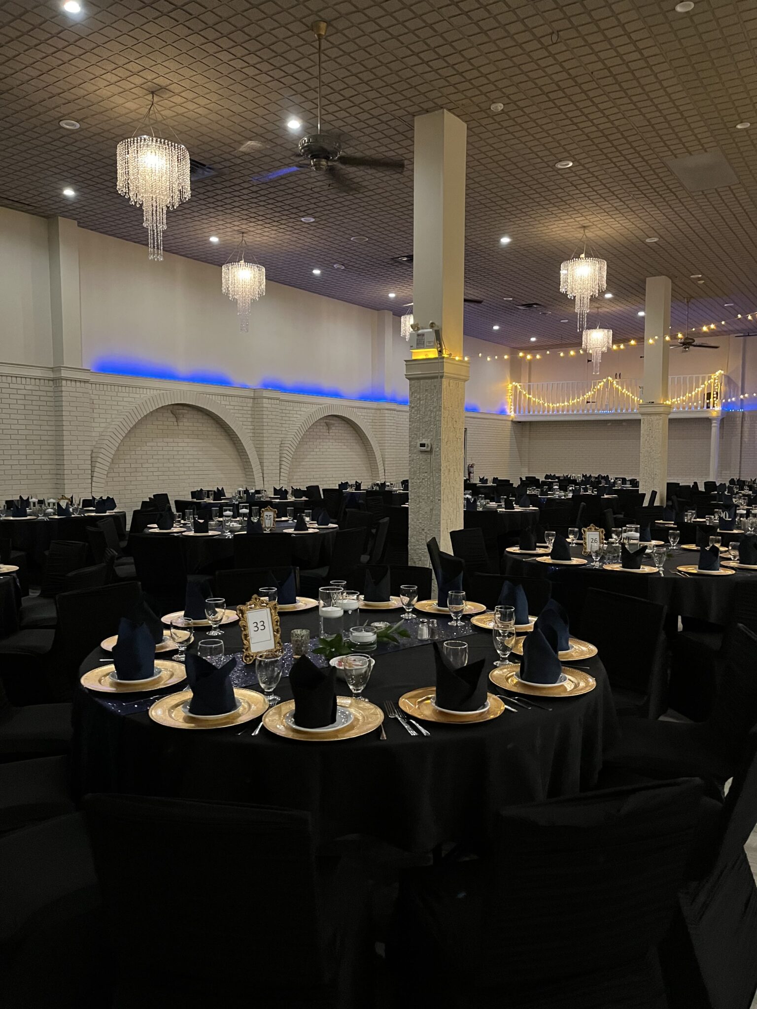 Tables dressed in black and gold for an event at Everest Convention Centre